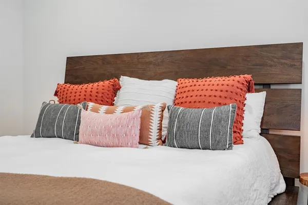 a bedroom with a large bed and a chandelier