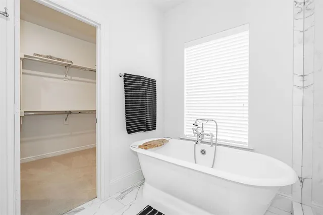 a spacious bathroom with a double vanity sink a mirror and a shower
