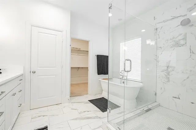 a white bath tub sitting next to a window