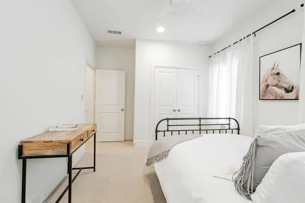 a bedroom with a bed and a table in it