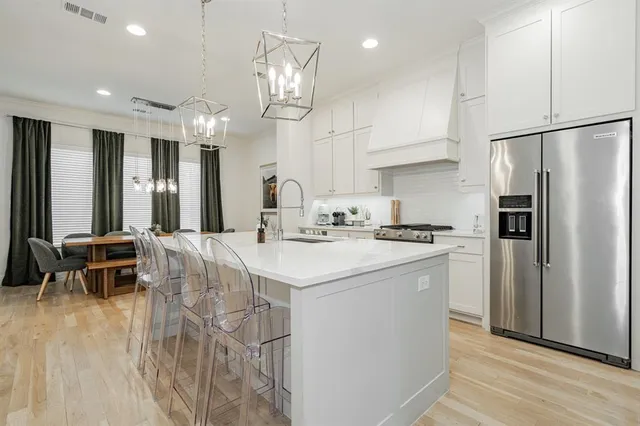 a kitchen with stainless steel appliances granite countertop a stove and a refrigerator