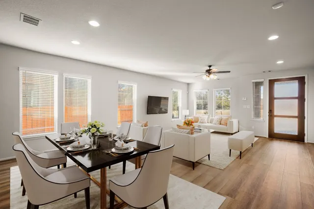 a living room with furniture and wooden floor