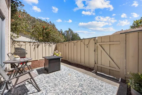 a view of a backyard with sitting area