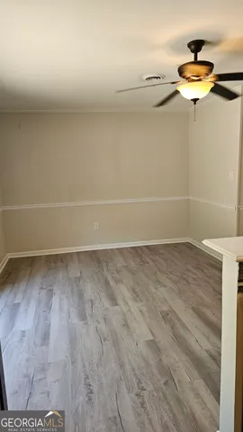 a view of a room with wooden floor