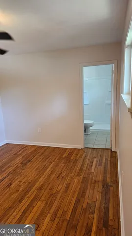 a view of a room with wooden floor and bench