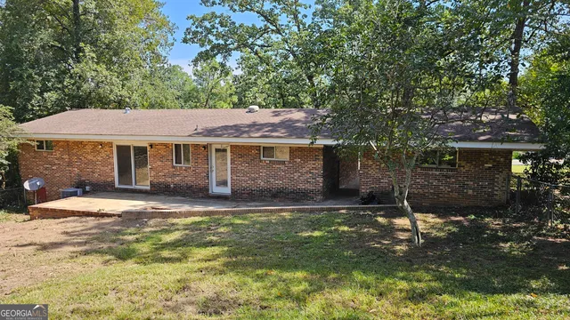 a backyard of a house with yard and outdoor seating