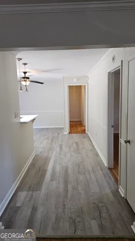 a view of empty room with wooden floor