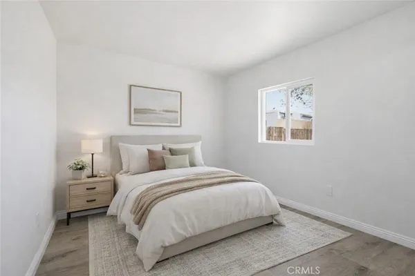 a bedroom with a bed and a night stand