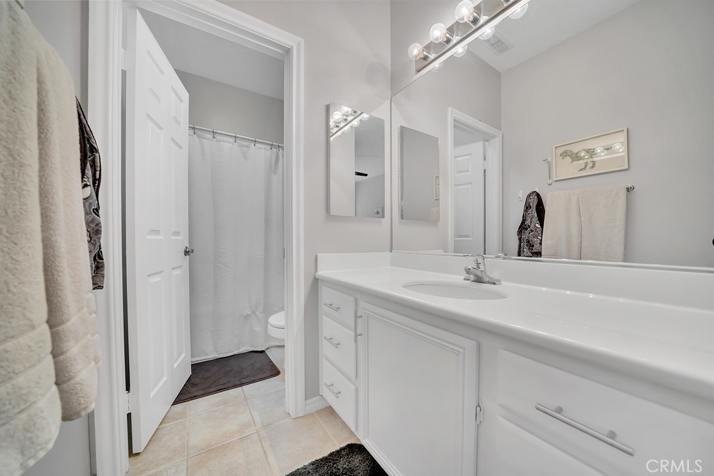 12 Geranium Irvine, CA 92618 - Photo 12 of 20 a bathroom with a double vanity sink and a mirror