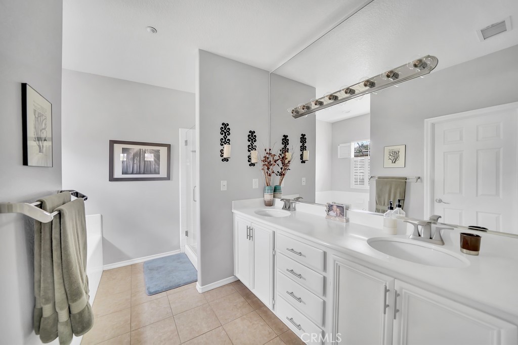 12 Geranium Irvine, CA 92618 - Photo 10 of 20 a spacious bathroom with double vanity a mirror and shower