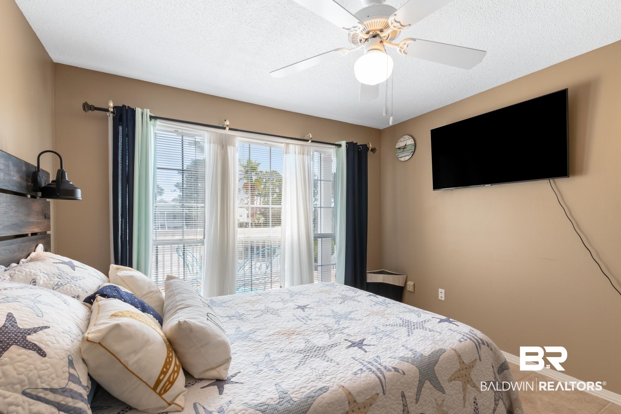 328 Windmill Ridge Road Gulf Shores, AL 36542 - Photo 18 of 47 Tiled bedroom featuring ceiling fan and a textured ceiling