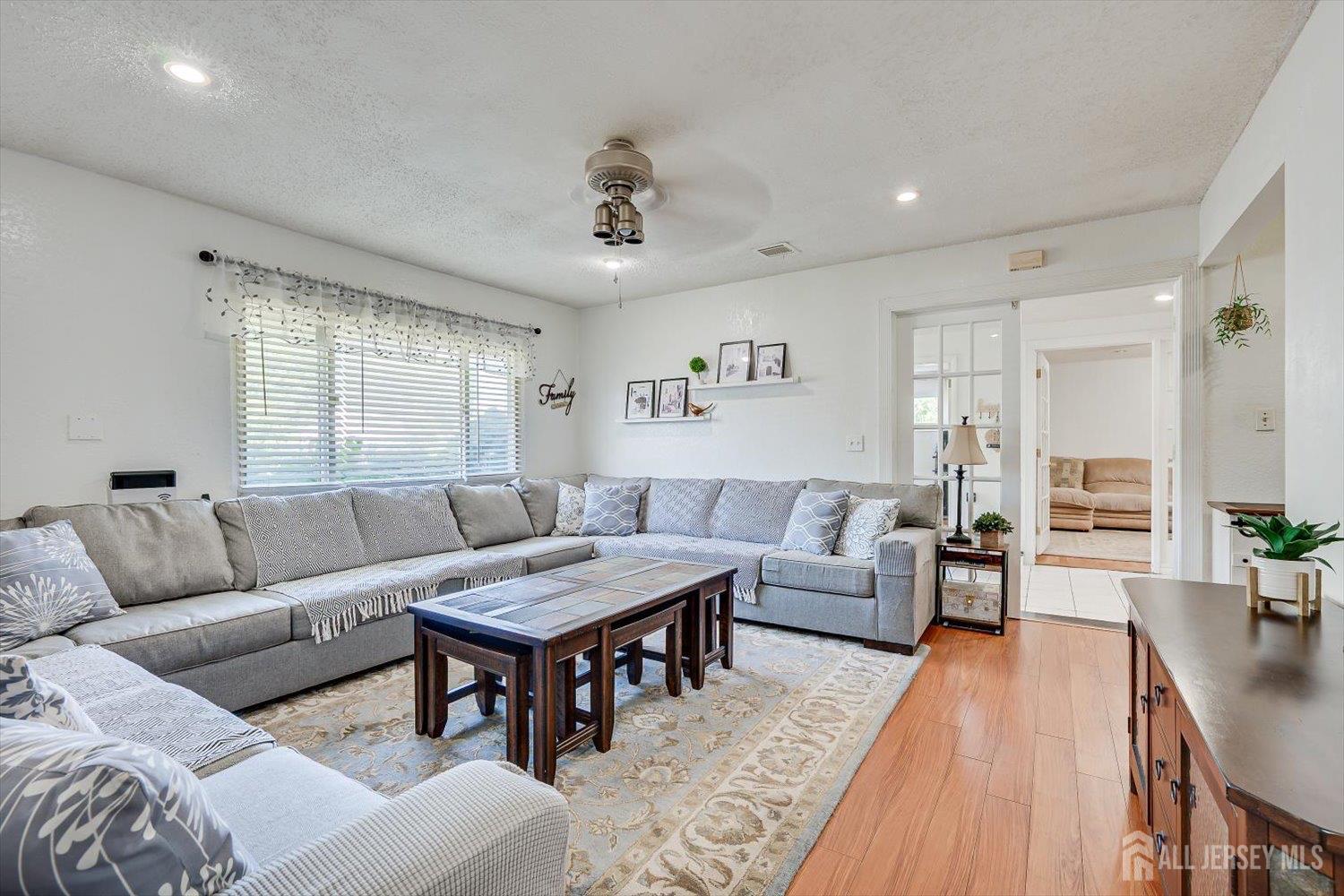a living room with furniture and wooden floor
