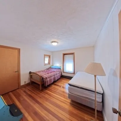 a bedroom with a bed and a night stand