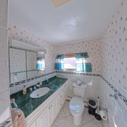 9 Raymond Street, Unit 1 Boston, MA 02134 - Photo 14 of 17 a bathroom with a granite countertop toilet sink and mirror