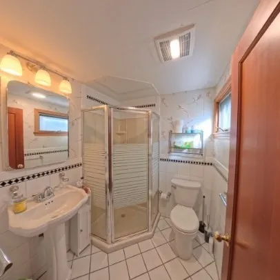 a bathroom with a sink toilet and shower