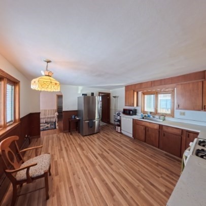 9 Raymond Street, Unit 1 Boston, MA 02134 - Photo 2 of 17 a large living room with stainless steel appliances granite countertop a couch a dining table and chairs with wooden floor