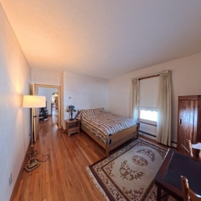 9 Raymond Street, Unit 1 Boston, MA 02134 - Photo 5 of 17 a bedroom with a bed window and a lamp with wooden floor
