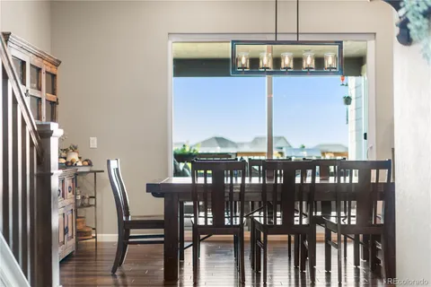 a view of a dining room with furniture and chandelier