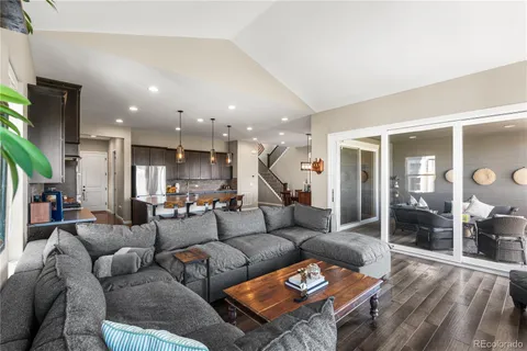 a living room with furniture and a wooden floor