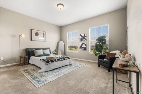 a living room with furniture a couch and a potted plant