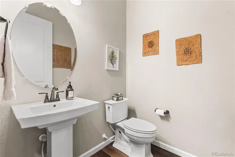 a bathroom with a sink mirror and toilet