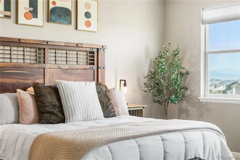 a bedroom with a bed and a potted plant