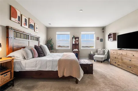 a bedroom with furniture and a flat screen tv