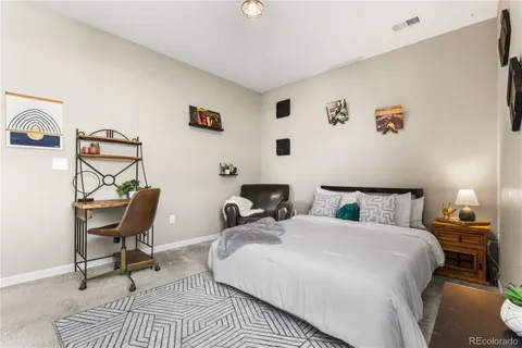 a bedroom with two beds and a chair