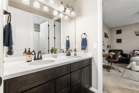 a bathroom with a sink double vanity and a mirror
