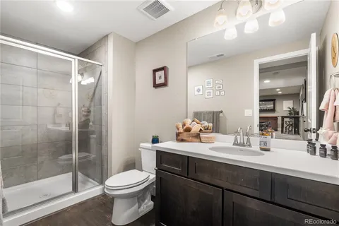 a bathroom with a sink toilet and shower