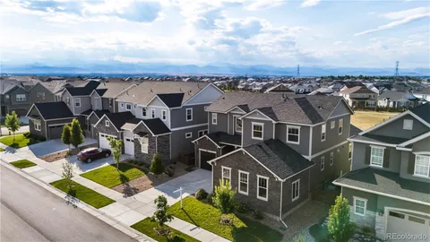 an aerial view of multiple houses with a yard
