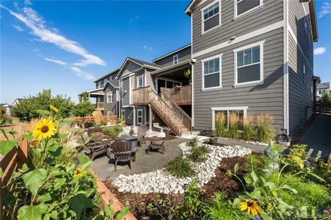 a view of a house with backyard and sitting area
