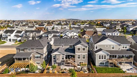 an aerial view of residential houses with city view