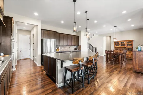 a large kitchen with a table and chairs