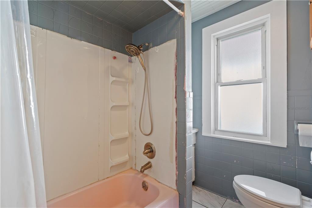 244 5th Street Johnstown, PA 15909 - Photo 22 of 36 a bathroom with a granite countertop bathtub shower sink vanity and toilet
