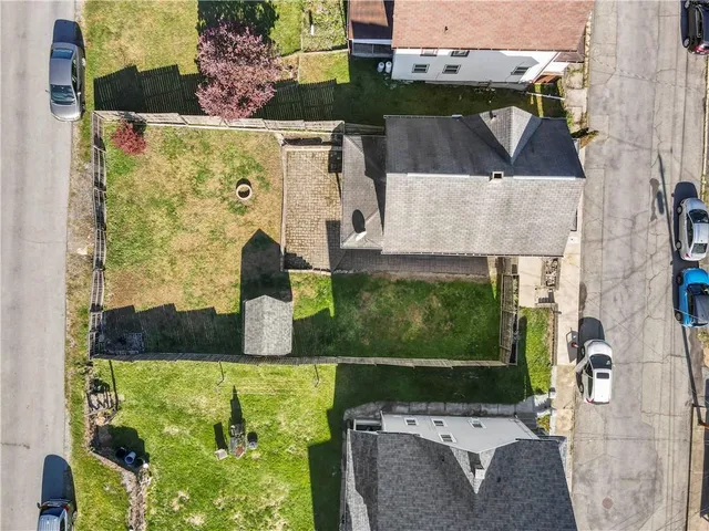 a front view of multiple houses with yard