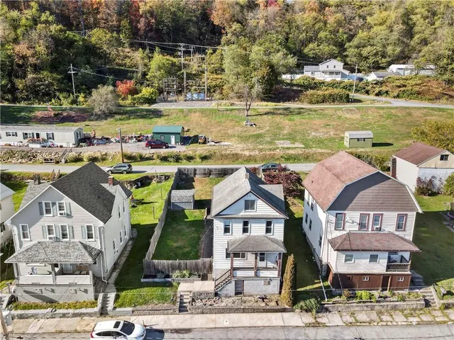 an aerial view of residential houses with outdoor space