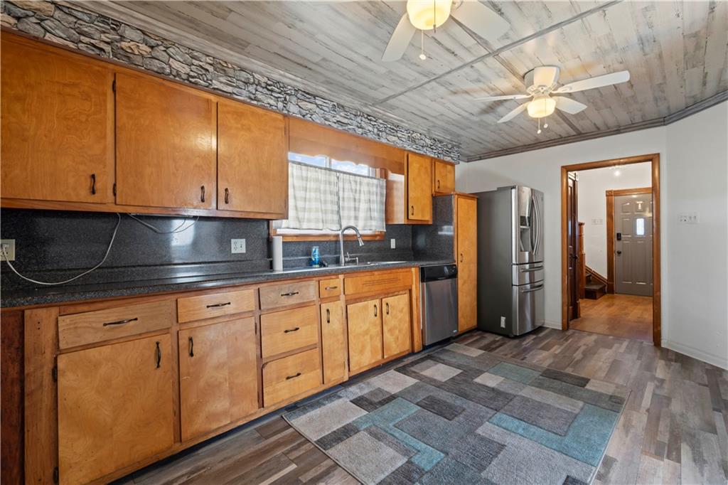 244 5th Street Johnstown, PA 15909 - Photo 5 of 36 a kitchen with stainless steel appliances granite countertop a sink a stove cabinets and wooden floor