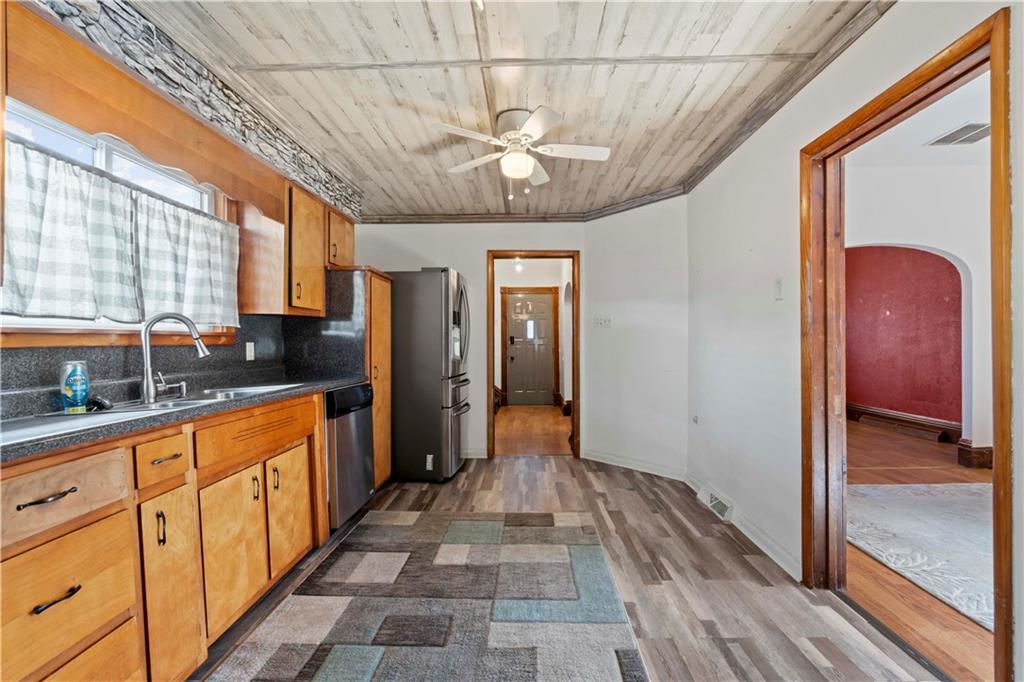 244 5th Street Johnstown, PA 15909 - Photo 6 of 36 a view of a hallway with wooden floor and staircase