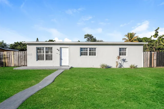 a view of a house with a yard and deck