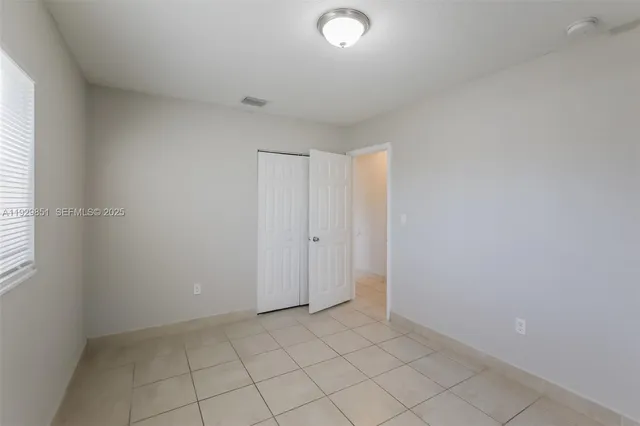 an empty room with white cabinet