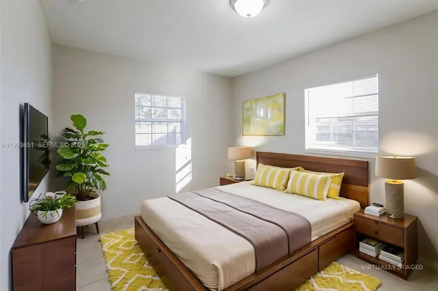 a bedroom with bed and a window