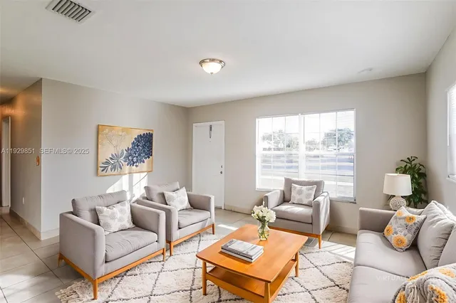 a living room with furniture and a large window