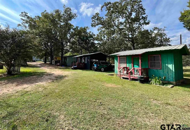 a view of a house with a yard porch and sitting area