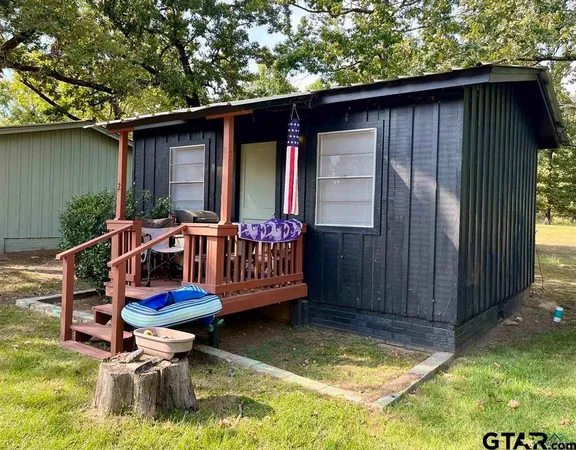 a front view of house with outdoor seating and yard