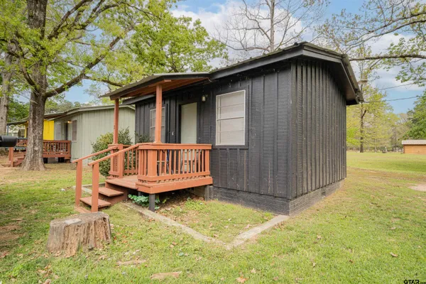a backyard of a house with table and chairs