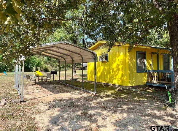 a swimming pool with outdoor seating and yard