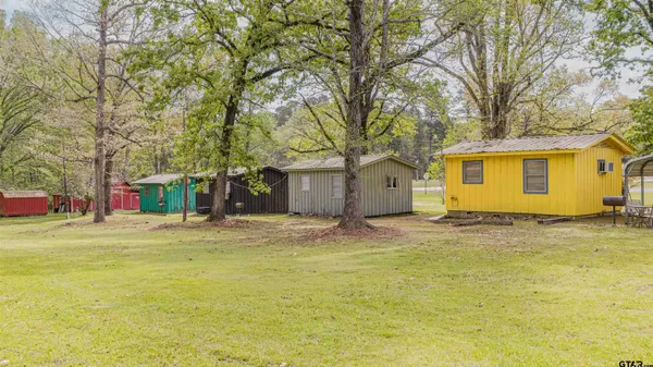 a big house with trees in front of it