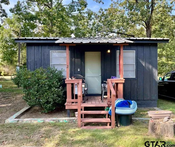 a view of a chair and table in backyard