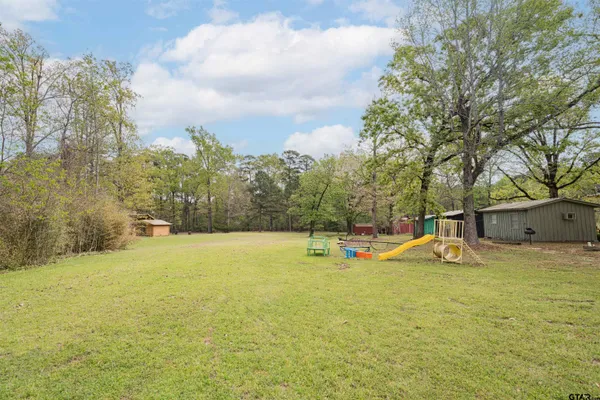 a view of a swimming pool with an outdoor seating and a yard